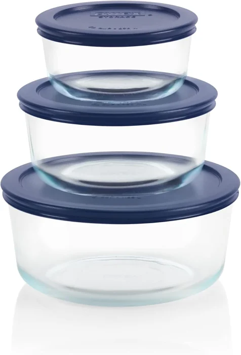 Three stacked round Pyrex Simply Store glass containers, 2, 4 and 7 cup, with navy blue lids